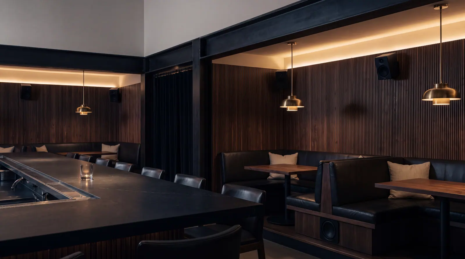 Design concept: an upscale restaurant dining room at night with compact loudspeakers set high on the walls above the banquettes.